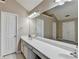 Spacious bathroom featuring double sinks, a wide mirror, and plenty of cabinets at 609 Grand Ashbury Ln, Buford, GA 30518