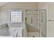 Bright bathroom featuring a soaking tub and a separate shower with glass door and tiled walls at 609 Grand Ashbury Ln, Buford, GA 30518