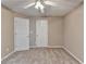 Carpeted bedroom with neutral walls, white trim, and a ceiling fan at 609 Grand Ashbury Ln, Buford, GA 30518