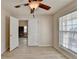 Bedroom featuring light colored floors and walls and a large window for natural lighting at 609 Grand Ashbury Ln, Buford, GA 30518