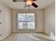 Inviting bedroom with vinyl floors, ceiling fan, and a window bringing in natural light at 609 Grand Ashbury Ln, Buford, GA 30518