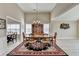 Dining room with hardwood floors, unique art, and a view into another dining area provides space at 609 Grand Ashbury Ln, Buford, GA 30518