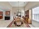 Dining room with wood table, chairs, chandelier, and hardwood floors is ideal for gatherings at 609 Grand Ashbury Ln, Buford, GA 30518