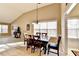 Dining room area with large windows, a modern table set and light-colored wood flooring at 609 Grand Ashbury Ln, Buford, GA 30518