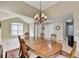 Elegant dining room boasts a chandelier, a large table, and hardwood floors at 609 Grand Ashbury Ln, Buford, GA 30518