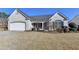 Charming single-story brick home with a two-car garage and manicured lawn at 609 Grand Ashbury Ln, Buford, GA 30518