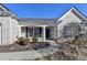 Charming home exterior with a covered front porch and well-maintained landscaping at 609 Grand Ashbury Ln, Buford, GA 30518