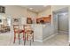Open concept kitchen features hardwood floors, an island with seating, and stainless steel appliances at 609 Grand Ashbury Ln, Buford, GA 30518
