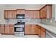 Well-equipped kitchen with ample counter space, wooden cabinets, and stainless steel appliances at 609 Grand Ashbury Ln, Buford, GA 30518