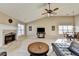 Open living room with a vaulted ceiling, fireplace, and ample natural light at 609 Grand Ashbury Ln, Buford, GA 30518