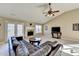 Bright living room with a fireplace, wood floors, and a comfortable leather sofa at 609 Grand Ashbury Ln, Buford, GA 30518