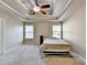 Bright main bedroom featuring a trey ceiling, carpet floors, and natural lighting at 609 Grand Ashbury Ln, Buford, GA 30518