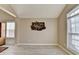 Living area boasts light hardwood floors, unique wall decor, and large windows for ample natural light at 609 Grand Ashbury Ln, Buford, GA 30518