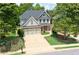 Beautiful two-story home with a two-car garage, lush landscaping, and a long driveway, nestled in a quiet neighborhood at 93 Richmond Way, Villa Rica, GA 30180