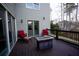 Relaxing back deck with a cozy fire table, comfortable seating, and wooded views at 93 Richmond Way, Villa Rica, GA 30180