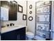 Charming powder room with black vanity, white countertop, decorative mirrors, and unique hand painted decorations at 93 Richmond Way, Villa Rica, GA 30180