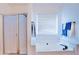 Bright bathroom featuring a soaking tub, shower, and a window bringing in natural light at 93 Richmond Way, Villa Rica, GA 30180