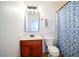Bathroom featuring a single sink vanity, standard toilet, and patterned shower curtain at 93 Richmond Way, Villa Rica, GA 30180