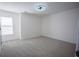 Empty bedroom with neutral carpet, light-colored walls, single window, and ceiling fan at 93 Richmond Way, Villa Rica, GA 30180