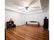 Spacious bedroom featuring wood floors, ceiling fan, neutral walls, and a door at 93 Richmond Way, Villa Rica, GA 30180