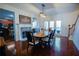 Elegant dining room with hardwood floors, a fireplace, and a view of the backyard through French doors at 93 Richmond Way, Villa Rica, GA 30180