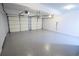 Clean garage featuring a durable epoxy floor and two white doors for vehicle storage at 93 Richmond Way, Villa Rica, GA 30180