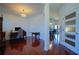 Hallway with views of a dining room and office featuring gleaming hardwood floors and neutral paint at 93 Richmond Way, Villa Rica, GA 30180
