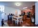 Open-concept kitchen with stainless steel appliances, granite countertops, dark wood cabinets, and an eat-in area at 93 Richmond Way, Villa Rica, GA 30180