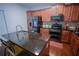 Modern kitchen with stainless steel appliances, granite countertops, dark wood cabinets, and a center island with seating at 93 Richmond Way, Villa Rica, GA 30180