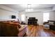 Living room features hardwood floors, two sofas, and large televisions for entertainment at 93 Richmond Way, Villa Rica, GA 30180