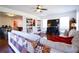Spacious living room featuring hardwood floors, a built-in bookcase, and a cozy seating area with a large TV at 93 Richmond Way, Villa Rica, GA 30180