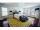 Spacious main bedroom with yellow rug, plush bedding, bedside tables, and lots of natural light at 93 Richmond Way, Villa Rica, GA 30180