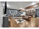 Entertainment room featuring leather furnishings, hardwood floors, and a built-in bar with shelving for ample storage at 154 Carmen Ln, Dallas, GA 30157