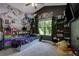Whimsical bedroom featuring a flower mural, a variety of stuffed animals, and a ceiling fan for comfort at 154 Carmen Ln, Dallas, GA 30157