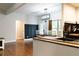 Modern dining area with dark accent wall, light fixture, and hardwood floors adjacent to the kitchen at 154 Carmen Ln, Dallas, GA 30157