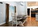 Bright dining area features a dark wood table with white chairs and benches, and a window with natural light at 154 Carmen Ln, Dallas, GA 30157