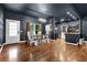 Dining area featuring a large wooden table with chairs, wood floors, and modern lighting at 154 Carmen Ln, Dallas, GA 30157