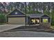Exterior of a blue home showcasing the two car garage, walkway, and stone accents around the entrance at 154 Carmen Ln, Dallas, GA 30157