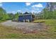 Back exterior of home featuring a large yard, back porch, and an outdoor grill at 154 Carmen Ln, Dallas, GA 30157