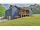 Back exterior of blue home with walkout basement, large yard, and back deck with stairs to the ground at 154 Carmen Ln, Dallas, GA 30157