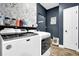 Laundry room with modern washer and dryer, floral wallpaper, and tiled floors at 154 Carmen Ln, Dallas, GA 30157