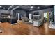 Open-concept living space with dark walls, wood floors, a fireplace, and a breakfast bar area at 154 Carmen Ln, Dallas, GA 30157