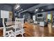 Open-concept living and dining area featuring dark walls, hardwood floors, and a stone fireplace at 154 Carmen Ln, Dallas, GA 30157