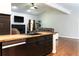 Open-concept living room and kitchen with stainless steel appliances, dark cabinets, and hardwood floors at 154 Carmen Ln, Dallas, GA 30157