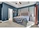 Spacious main bedroom featuring a large bed, accent wall, and windows with curtains at 154 Carmen Ln, Dallas, GA 30157