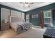 Serene main bedroom with tray ceiling, decorative accent wall, and soft natural light at 154 Carmen Ln, Dallas, GA 30157