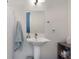 Bright bathroom featuring a modern vanity with a pedestal sink and framed mirror at 1606 Rock Dam Dr # 11, Atlanta, GA 30317