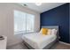 Cozy bedroom features a large window, blue accent wall, and neutral-toned furnishings at 1606 Rock Dam Dr # 11, Atlanta, GA 30317