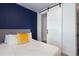 Bedroom with navy accent wall featuring barn door and neutral colored decor at 1606 Rock Dam Dr # 11, Atlanta, GA 30317