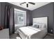 Comfortable bedroom with a plush bed, dark curtains, and neutral gray walls at 1606 Rock Dam Dr # 11, Atlanta, GA 30317